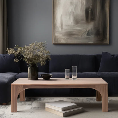 Arched leg coffee table styled in soft living room setting with sculptural presence and clean layout