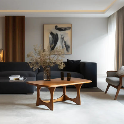 Art form coffee table with carved arched legs and modern top in a designer living room