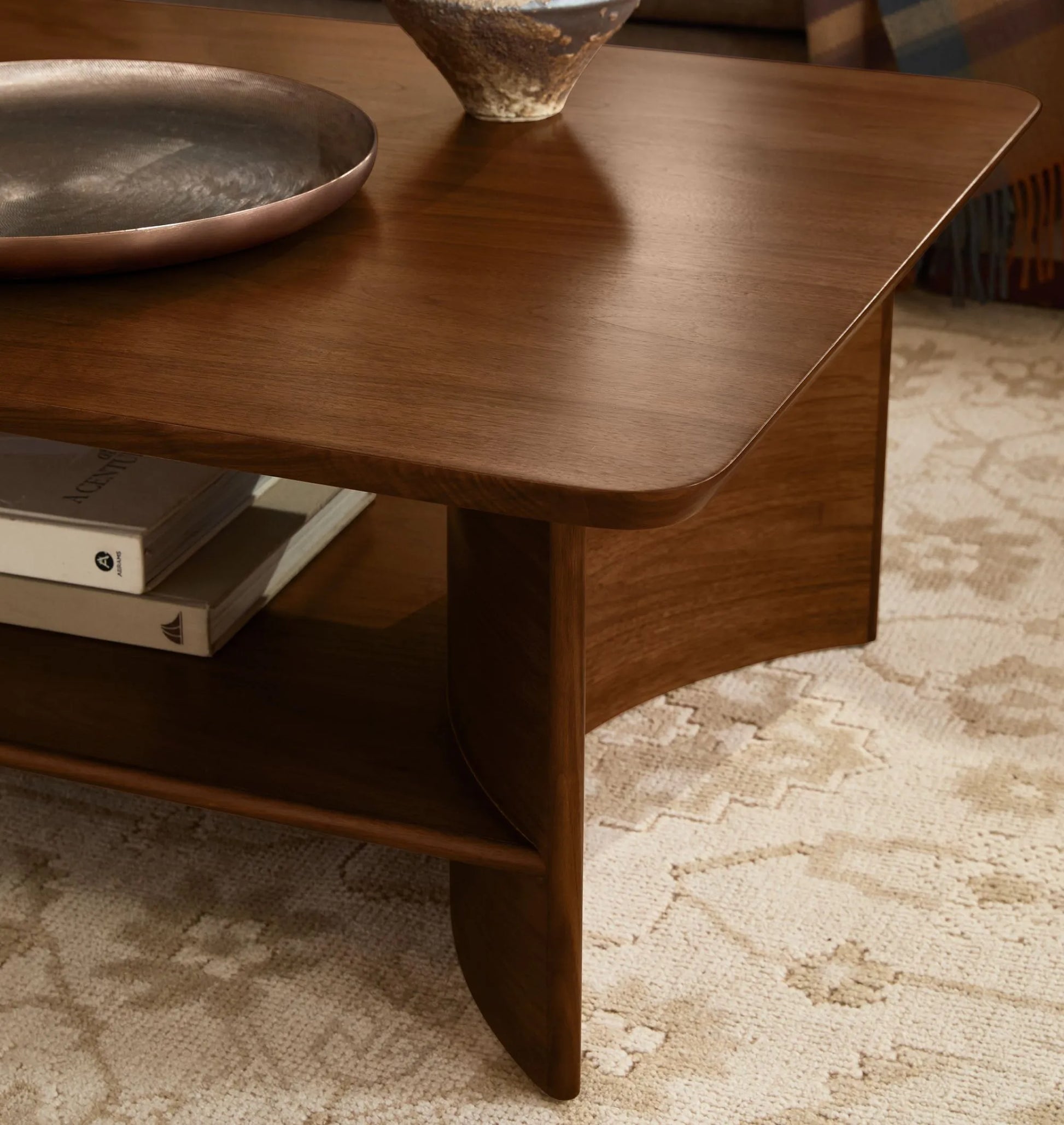 Contemporary Curved Coffee Table with rich wood finish and lower shelf