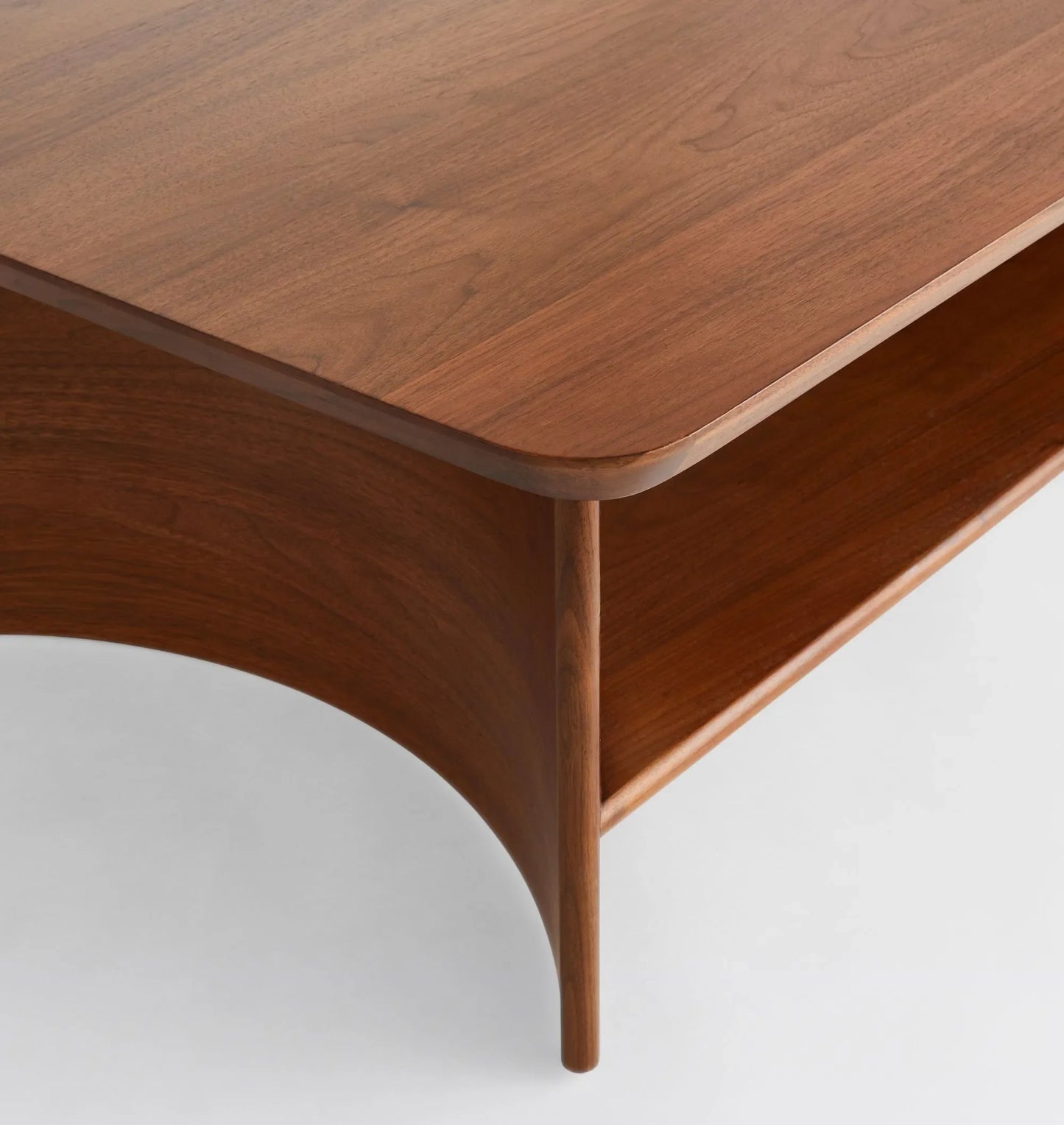 Contemporary Curved Coffee Table with rich wood finish and lower shelf