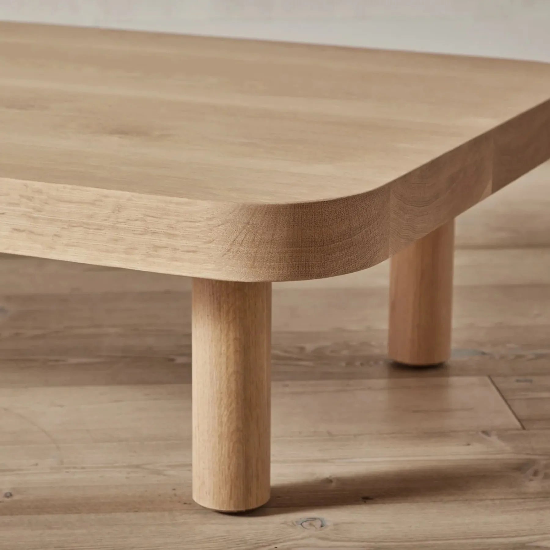 Contemporary Low Profile Coffee Table with rounded edges and sturdy cylindrical legs