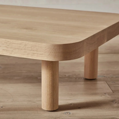 Contemporary Low Profile Coffee Table with rounded edges and sturdy cylindrical legs