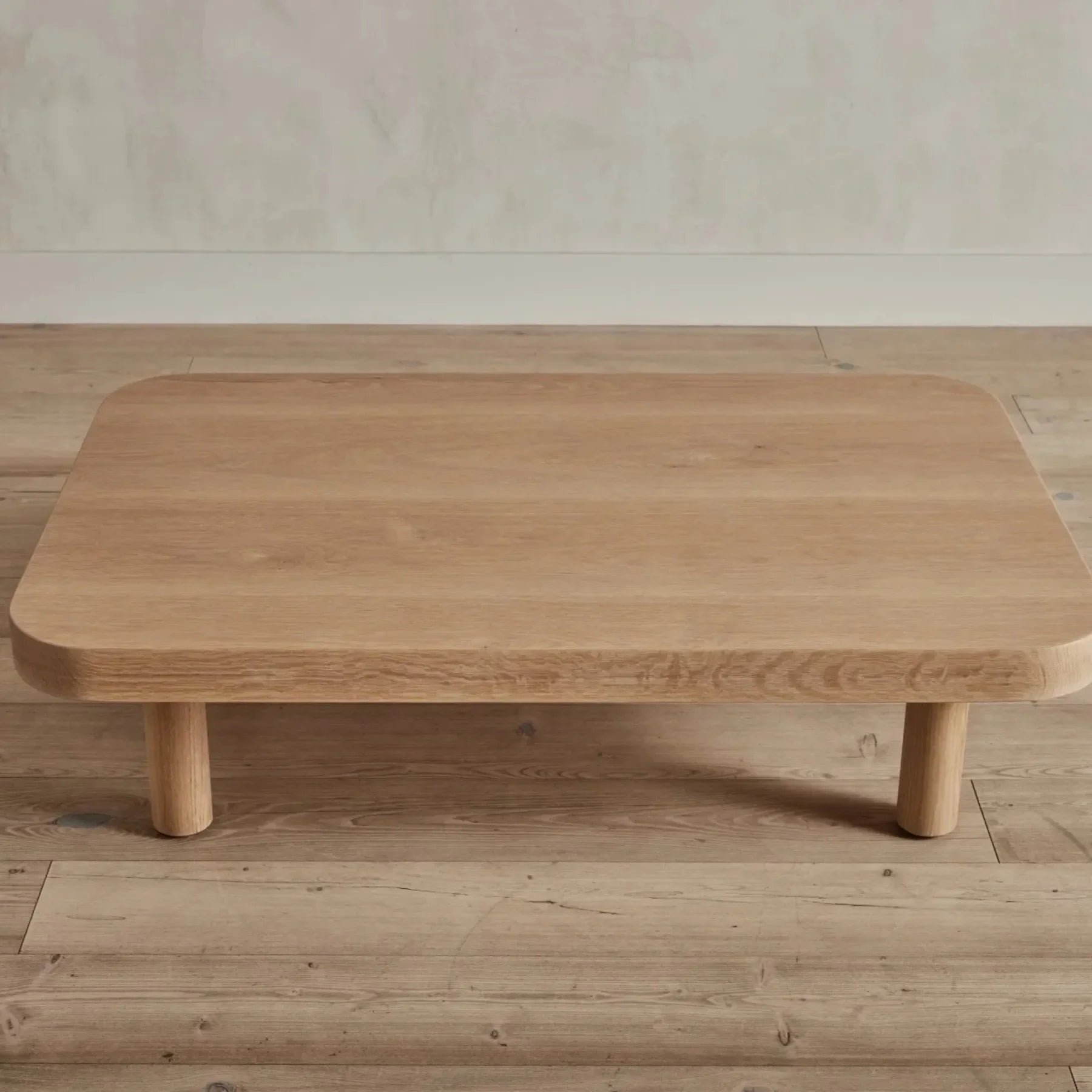 Contemporary Low Profile Coffee Table with rounded edges and sturdy cylindrical legs