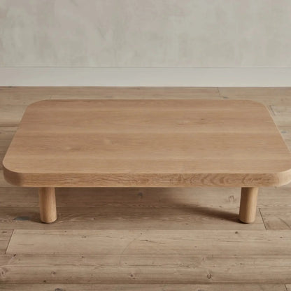 Contemporary Low Profile Coffee Table with rounded edges and sturdy cylindrical legs