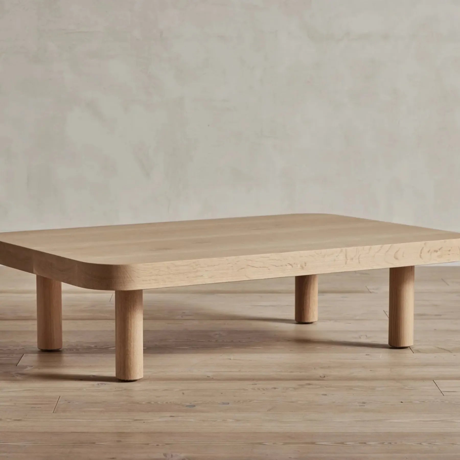 Contemporary Low Profile Coffee Table with rounded edges and sturdy cylindrical legs