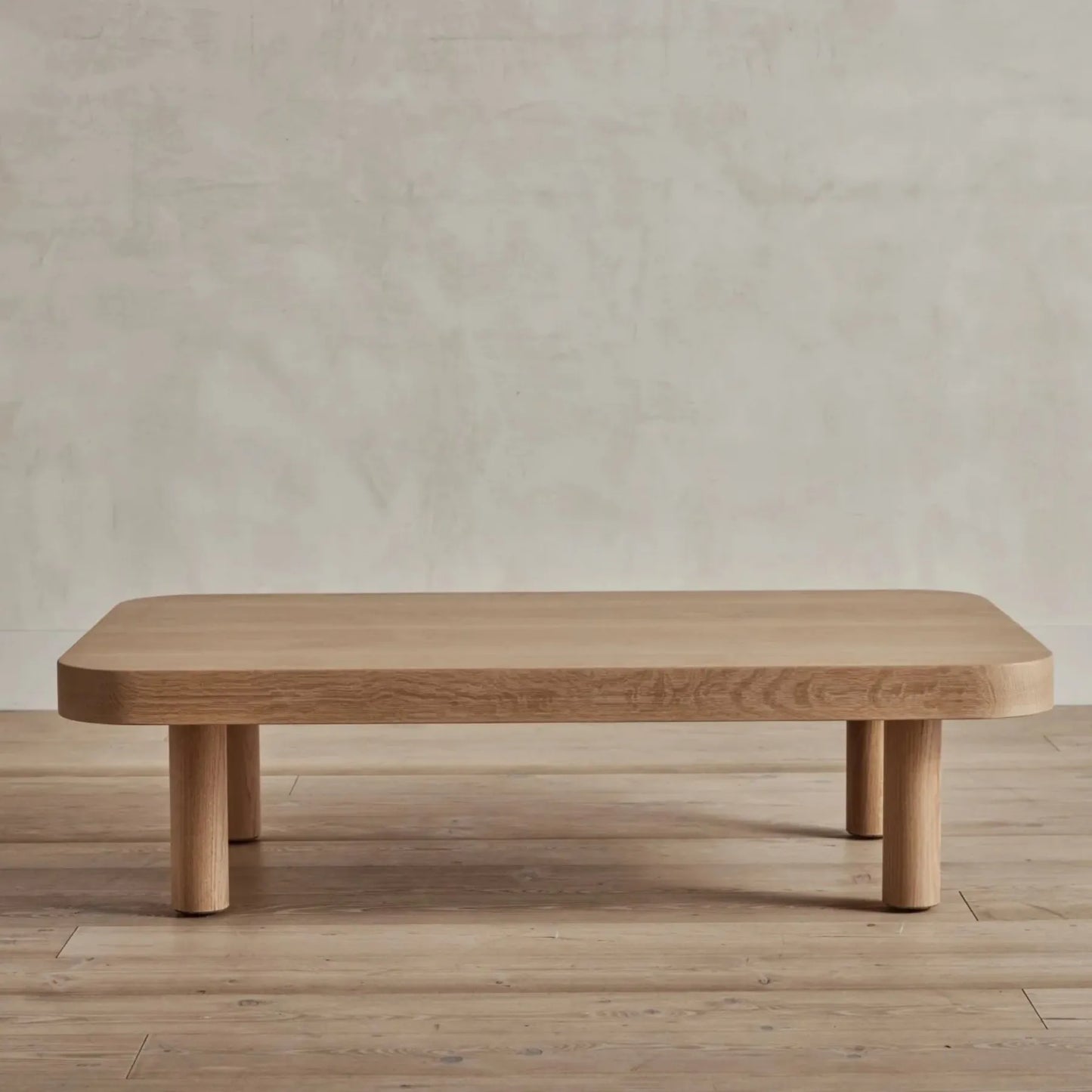 Contemporary Low Profile Coffee Table with rounded edges and sturdy cylindrical legs