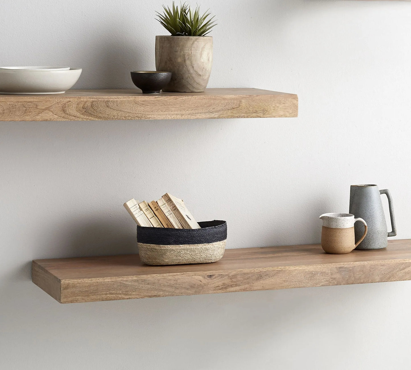 Contemporary wall mounted shelf styled with plants and decor items