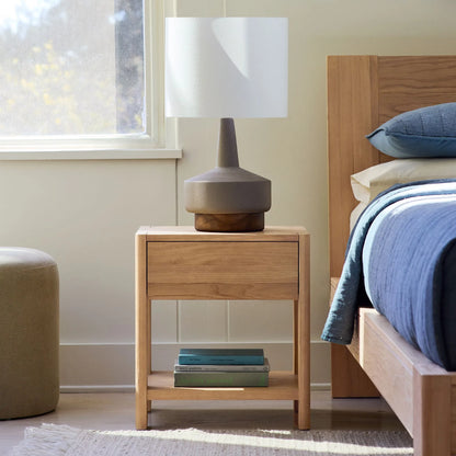 Elegant bedroom nightstand storage, featuring a drawer and open shelf