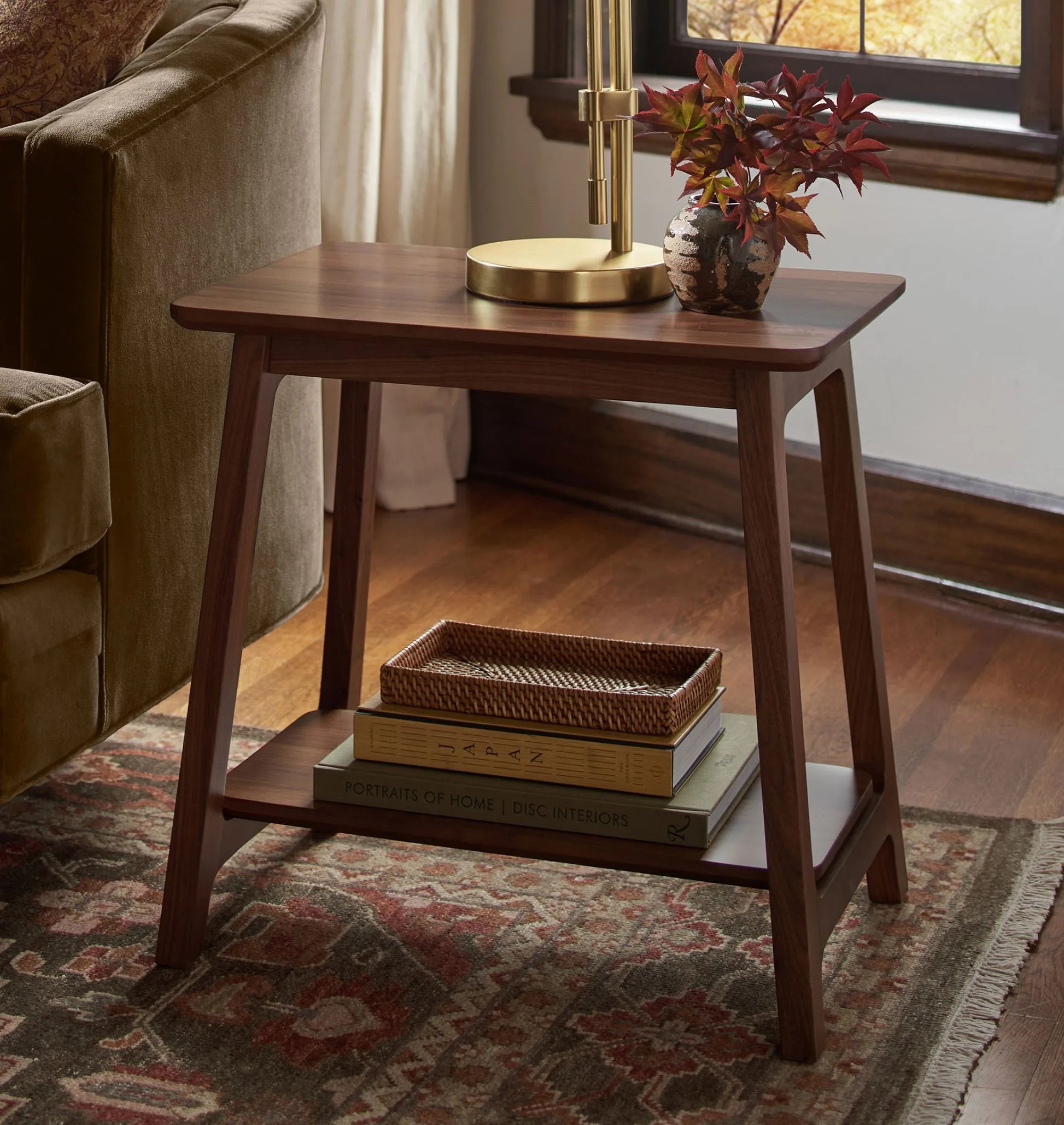 Elegant compact wooden side table with open lower shelf in a cozy room