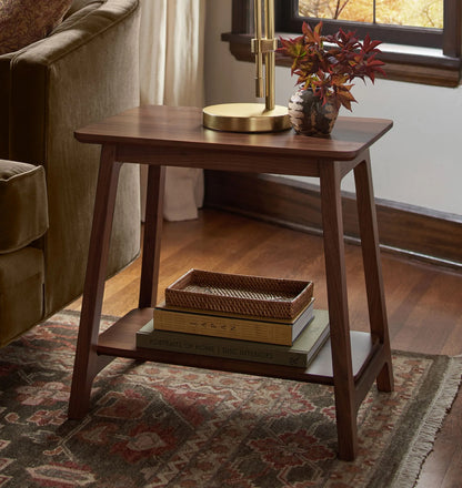 Elegant compact wooden side table with open lower shelf in a cozy room