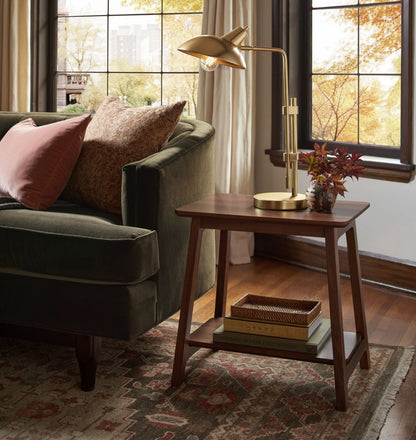 Elegant compact wooden side table with open lower shelf in a cozy room