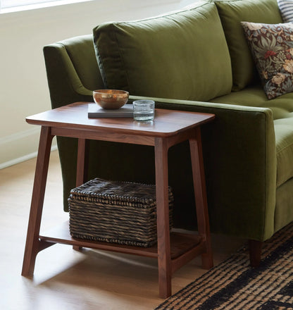 Elegant compact wooden side table with open lower shelf in a cozy room