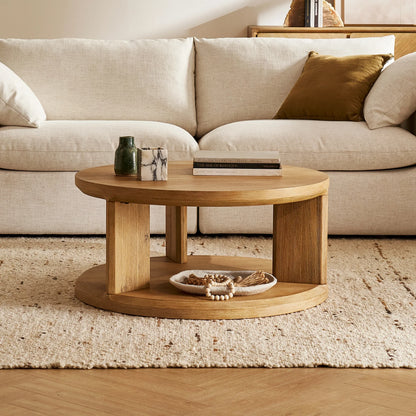 Elegant round coffee table with a spacious surface and open storage shelf