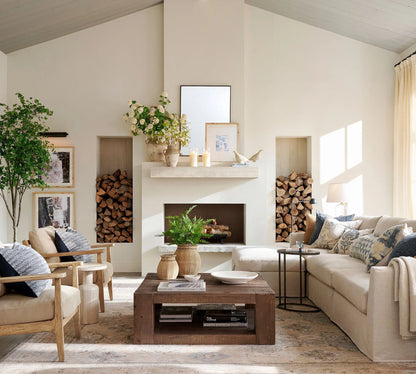 Elegant wall shelf decorated with framed art, candles, and sculptures