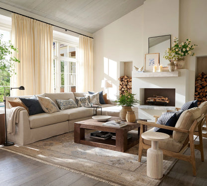 Elegant wall shelf decorated with framed art, candles, and sculptures