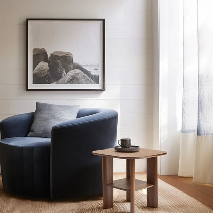 Everyday side table with square top and lower shelf styled in a cozy modern reading corner