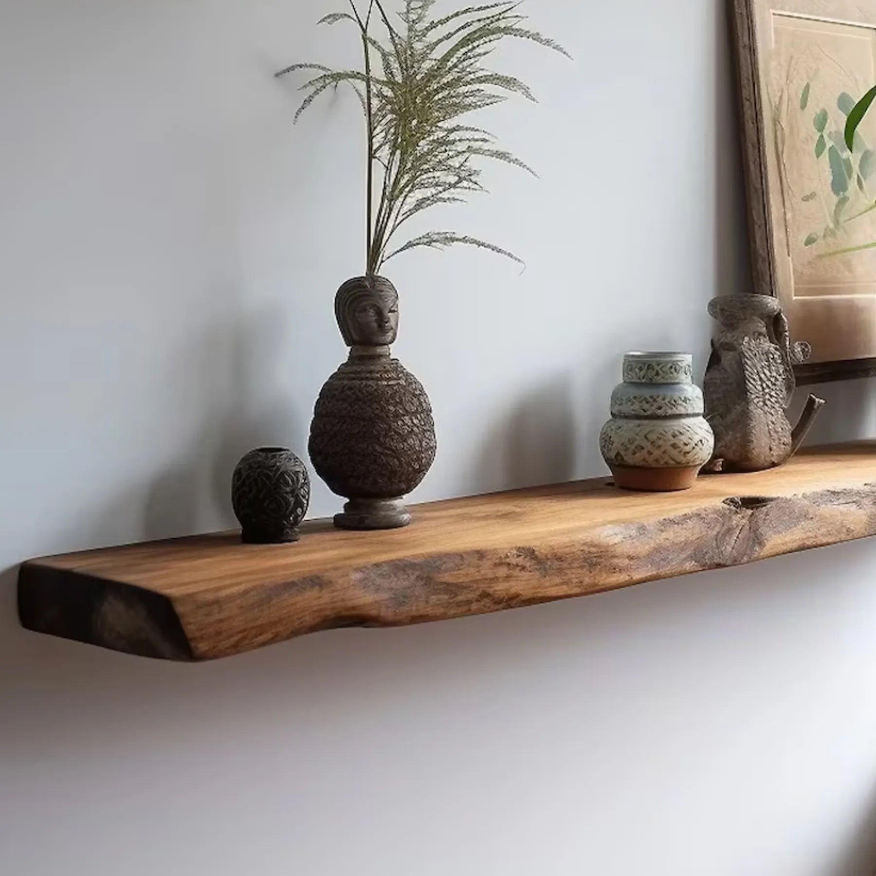 Floating shelf natural edge mounted on a wall displaying decor and plants