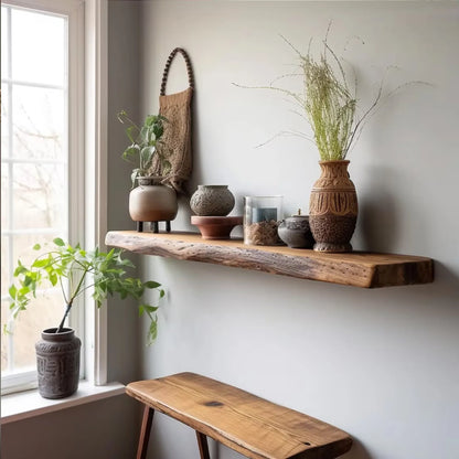 Floating shelf natural edge mounted on a wall displaying decor and plants