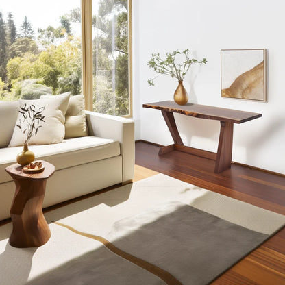 Live edge console table with angled legs styled in a sunlit modern living room