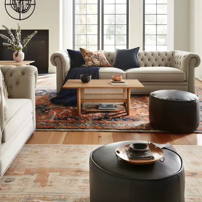 Mid century coffee table with woven shelf placed in cozy living room