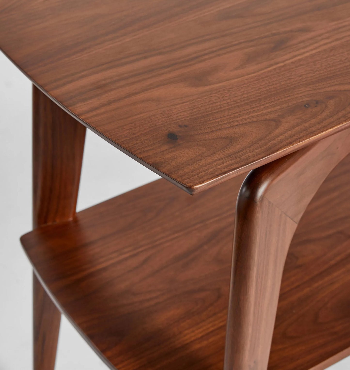 Mid century console table with curved edges, tapered legs, and two spacious shelves.