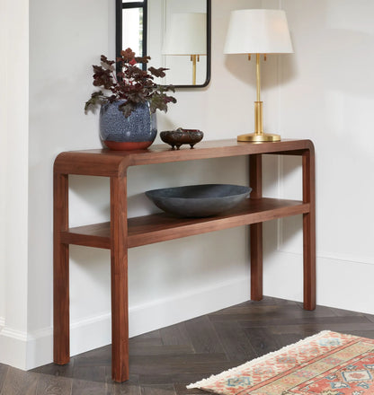 Mid century console table with rounded edges and two-tier shelves for decor and storage.