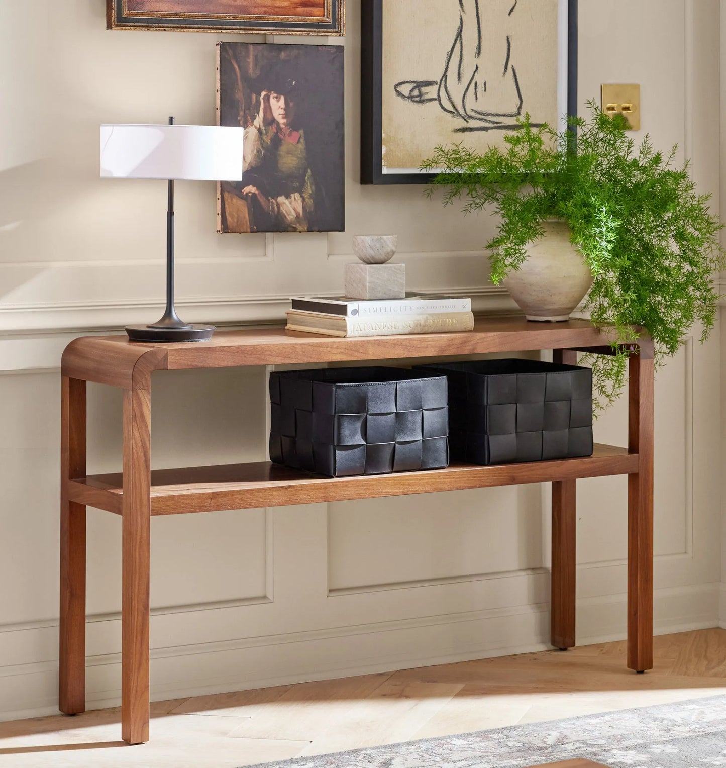 Mid century console table with rounded edges and two-tier shelves for decor and storage.