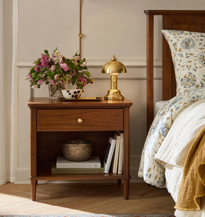 Mid century nightstand with open shelf, single drawer, and brass knob.