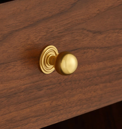 Mid century nightstand with open shelf, single drawer, and brass knob.