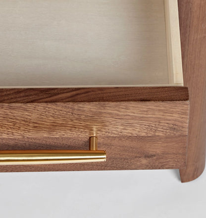 Mid century nightstand with single drawer, open shelf, and tapered legs.