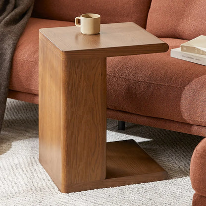 Modern C shaped side table with open base and curved edges perfect for small living spaces