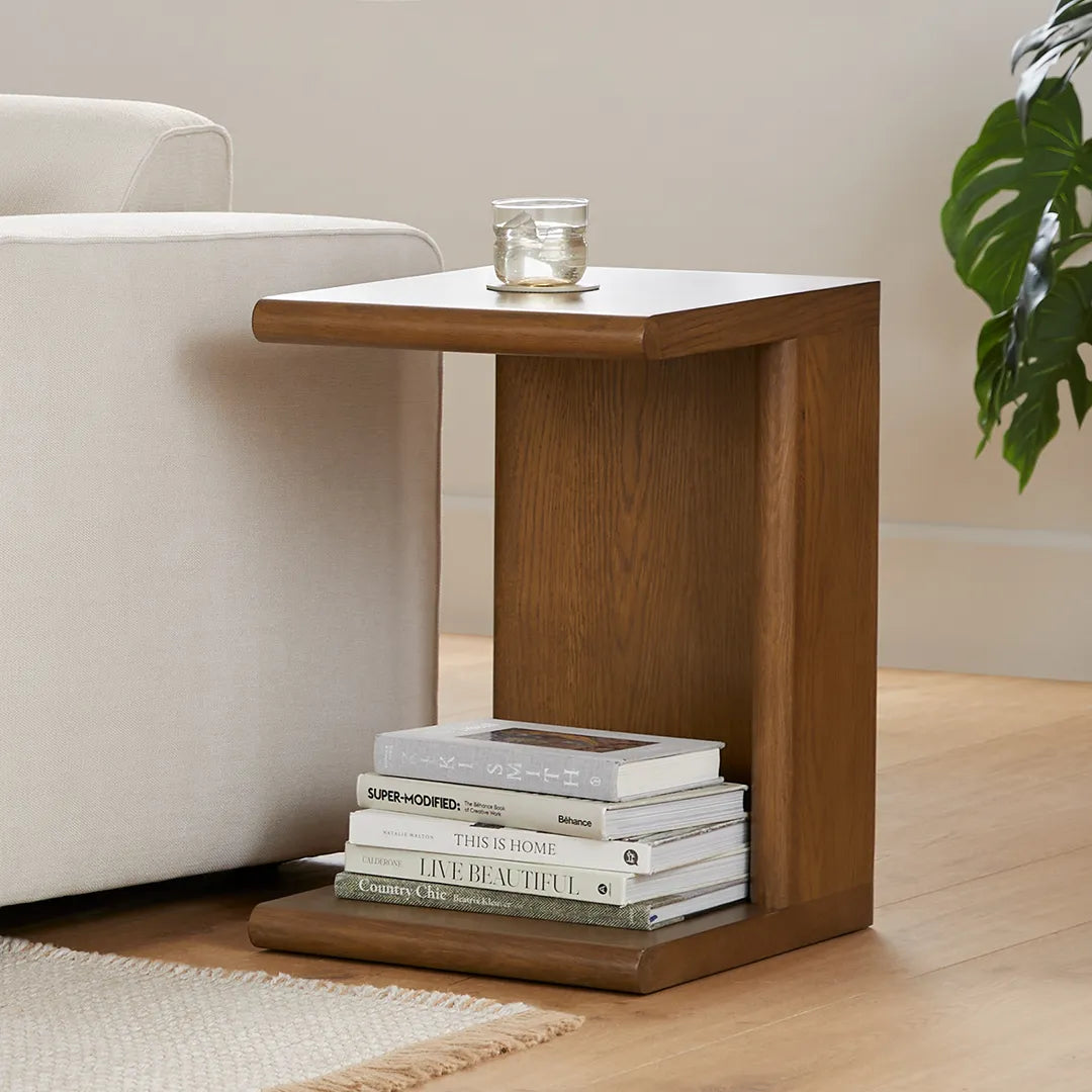 Modern C shaped side table with open base and curved edges perfect for small living spaces