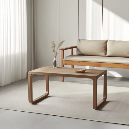 Modern curved wooden coffee table with minimalist style.